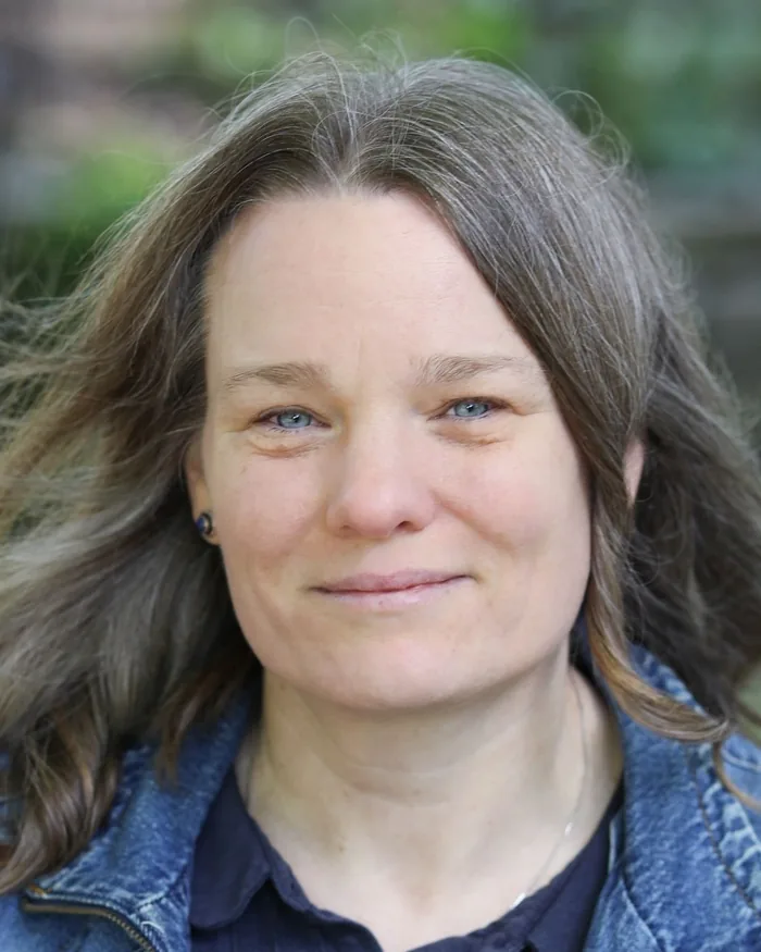 Tjitske Kamphuis, the artist behind the shop, smiling outdoors